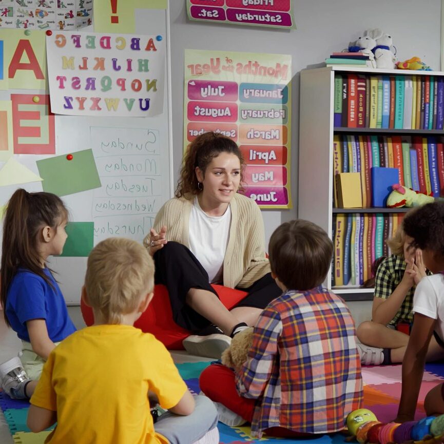 Teacher reading to children in classroom circle.
